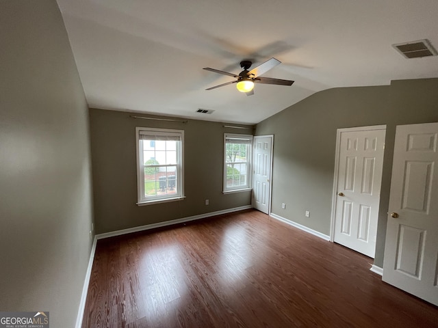 211 Buckland Dr, Alpharetta, GA 30022 - unfurnished bedroom with vaulted ceiling, dark wood-style floors, two closets, baseboards, and a ceiling fan