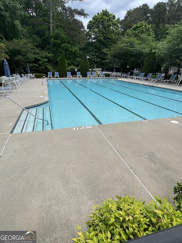 211 Buckland Dr, Alpharetta, GA 30022 - community pool with a patio area and view of scattered trees