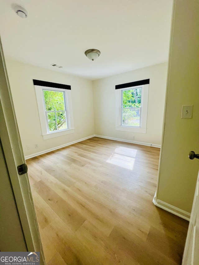 2502 Barge Rd SW, Atlanta, GA 30331 - empty room featuring baseboards, a wealth of natural light, and light wood-type flooring