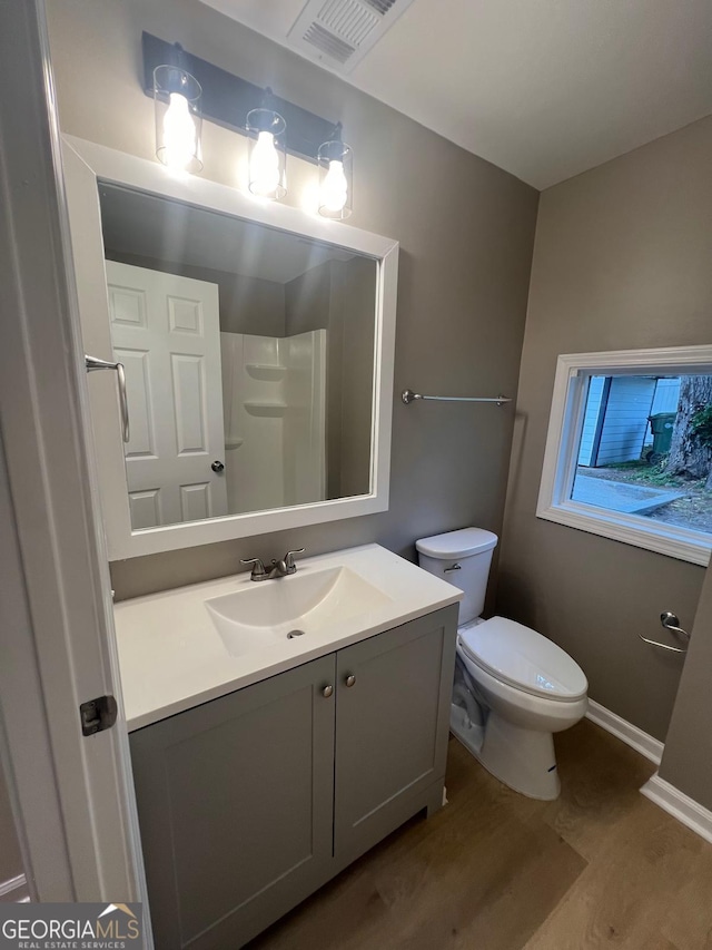 2502 Barge Rd SW, Atlanta, GA 30331 - full bathroom with visible vents, vanity, wood finished floors, toilet, and walk in shower