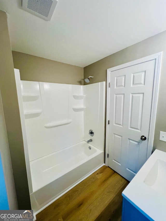2502 Barge Rd SW, Atlanta, GA 30331 - bathroom featuring shower / bathtub combination, vanity, wood finished floors, and visible vents