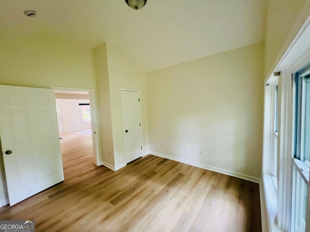 2502 Barge Rd SW, Atlanta, GA 30331 - unfurnished bedroom featuring baseboards, wood finished floors, and high vaulted ceiling