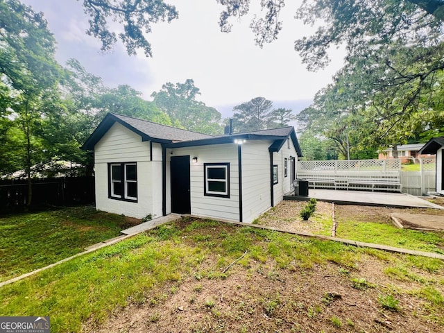 2502 Barge Rd SW, Atlanta, GA 30331 - rear view of property featuring a lawn, fence, and central AC unit