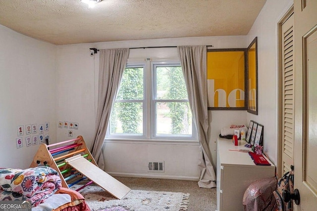 2621 Manor Pl, Ellenwood, GA 30294 - bedroom featuring carpet flooring, a textured ceiling, baseboards, and visible vents