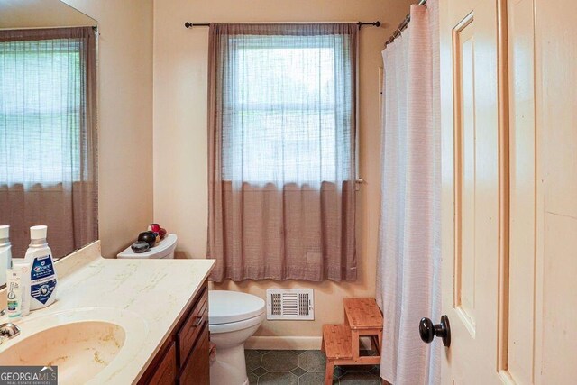 2621 Manor Pl, Ellenwood, GA 30294 - bathroom featuring vanity, tile patterned flooring, toilet, and visible vents