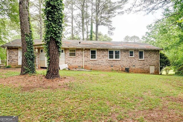 2621 Manor Pl, Ellenwood, GA 30294 - rear view of property with a lawn, cooling unit, brick siding, and crawl space