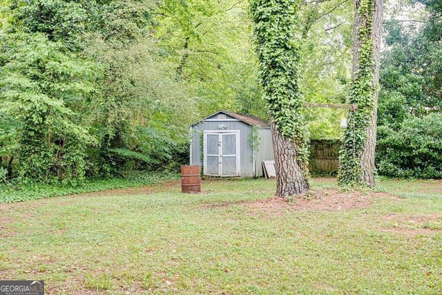 2621 Manor Pl, Ellenwood, GA 30294 - view of yard featuring a storage unit, an outdoor structure, and fence