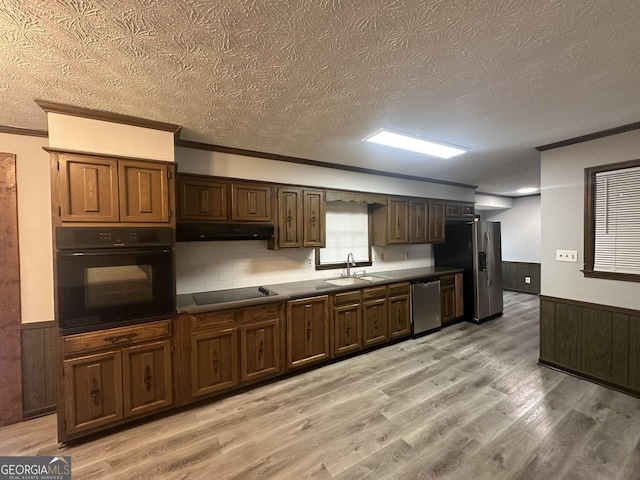 kitchen featuring crown molding, black appliances, and a textured ceiling