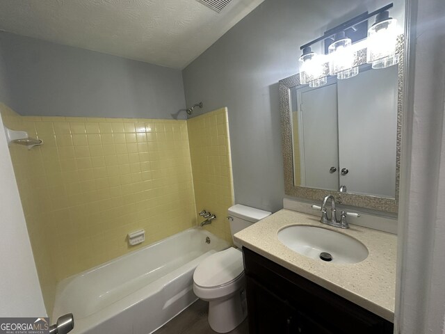 bathroom with bathing tub / shower combination, vanity, toilet, and wood finished floors