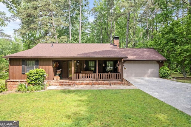 single story home featuring covered porch, a chimney, a front yard, a garage, and concrete driveway