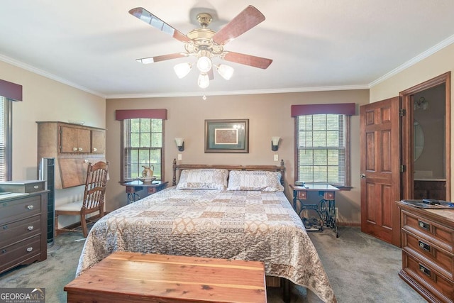 carpeted bedroom with crown molding, baseboards, and ceiling fan
