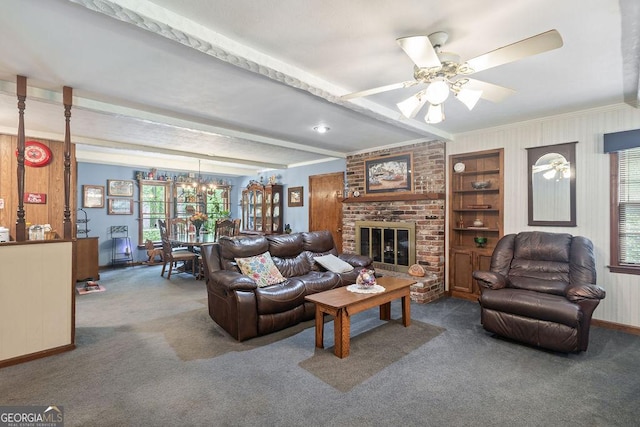 carpeted living area featuring ceiling fan, a fireplace, beam ceiling, baseboards, and ornamental molding