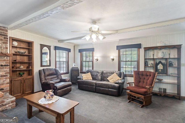carpeted living room with visible vents, crown molding, a wealth of natural light, and beamed ceiling