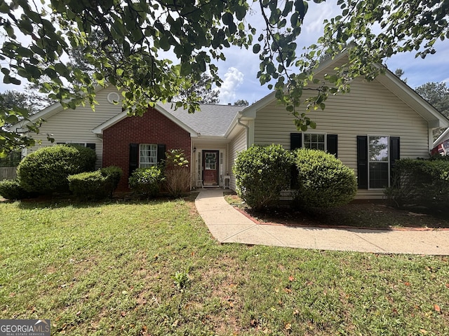 single story home with a front lawn and brick siding