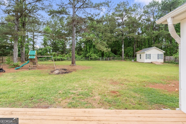 308 Dylan Way, Mcdonough, GA 30252 - view of yard featuring a playground, view of scattered trees, and a deck