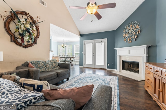 308 Dylan Way, Mcdonough, GA 30252 - living area with dark wood-type flooring, a ceiling fan, a chandelier, a fireplace, and high vaulted ceiling