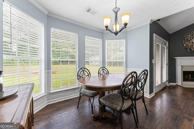 308 Dylan Way, Mcdonough, GA 30252 - dining space with a chandelier, wood-type flooring, a fireplace, crown molding, and baseboards