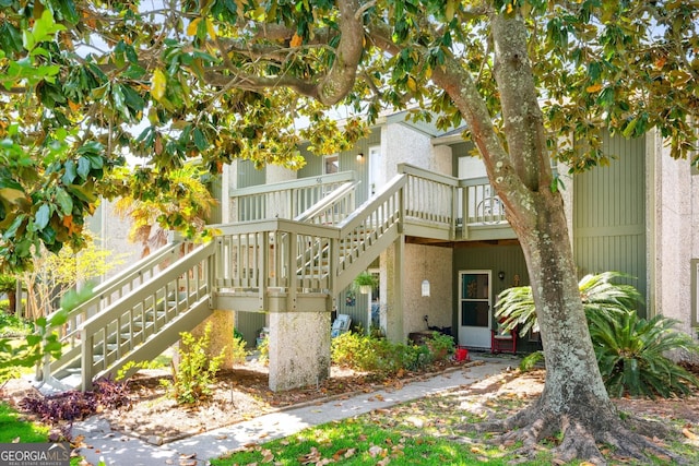 back of property featuring stairway