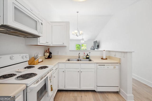 kitchen featuring a sink, white cabinets, light wood finished floors, a chandelier, and white appliances