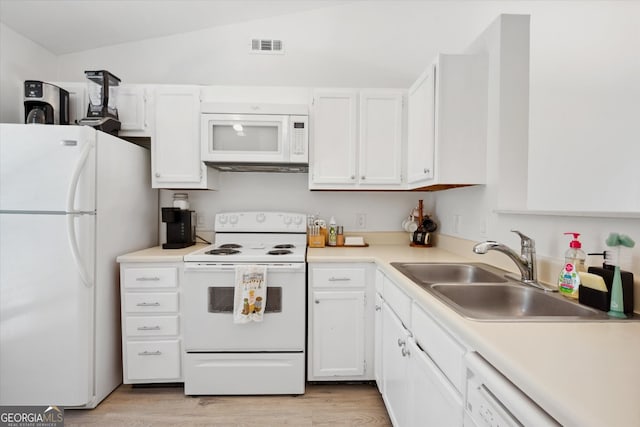 kitchen with a sink, white cabinets, white appliances, and light countertops