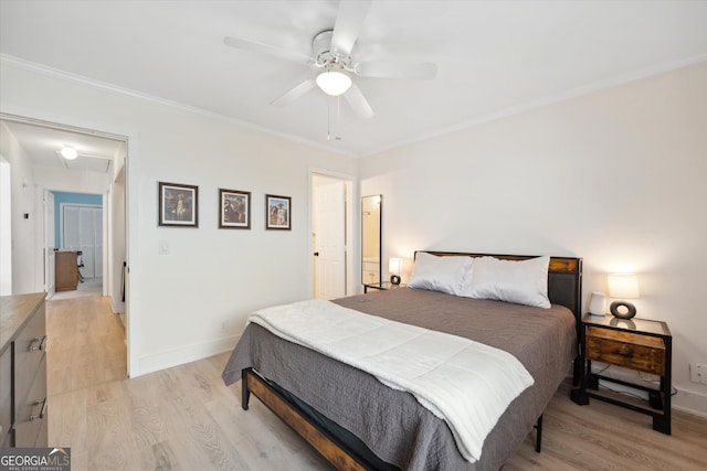 bedroom with ceiling fan, attic access, crown molding, baseboards, and light wood-style floors