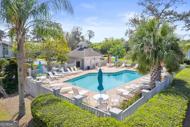 pool with fence and a patio area