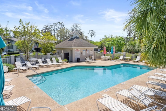 community pool featuring a patio area and fence
