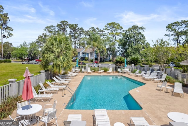 pool with fence and a patio area