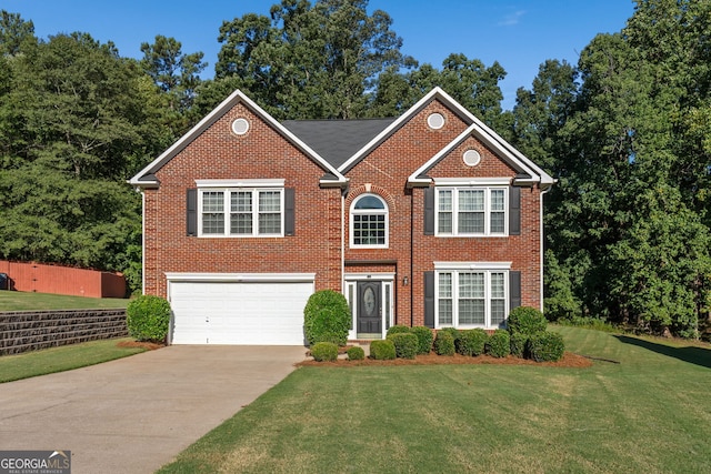 view of front of property with brick siding, an attached garage, driveway, and a front yard