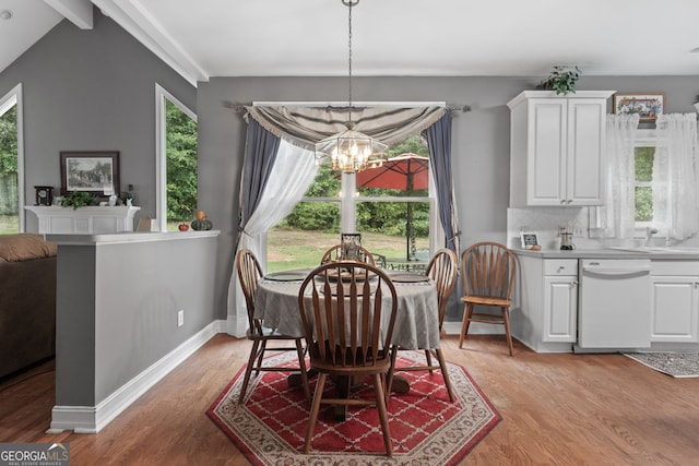 dining area featuring light wood-type flooring, baseboards, a notable chandelier, and beamed ceiling
