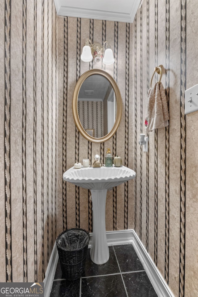 bathroom with crown molding, tile patterned floors, and baseboards