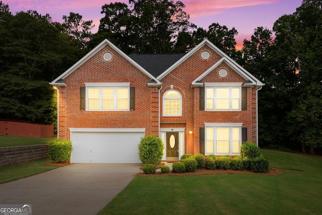 view of front of house featuring a garage, concrete driveway, and brick siding