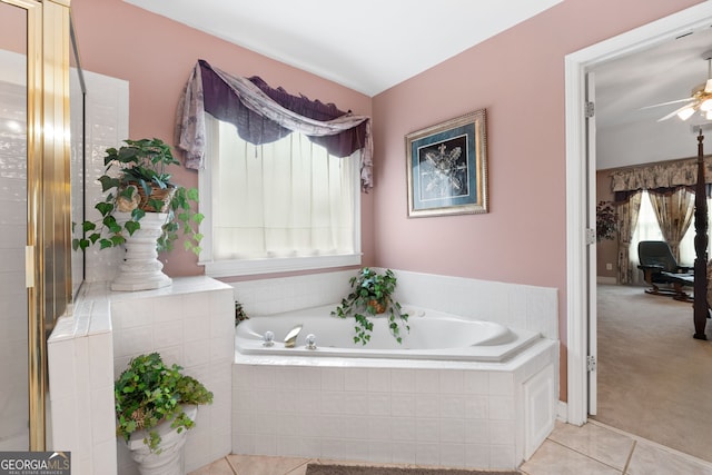 bathroom featuring tile patterned flooring, ceiling fan, and a garden tub