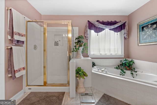 bathroom with tile patterned floors, a bath, and a shower stall