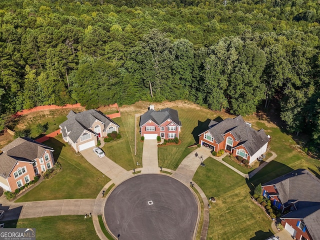 drone / aerial view with a residential view and a forest view