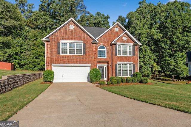 view of front facade featuring an attached garage, concrete driveway, a front lawn, and brick siding
