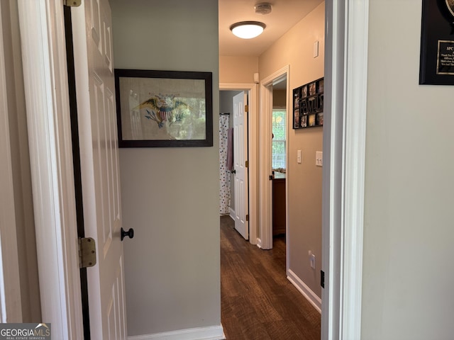 hall with baseboards and dark wood finished floors