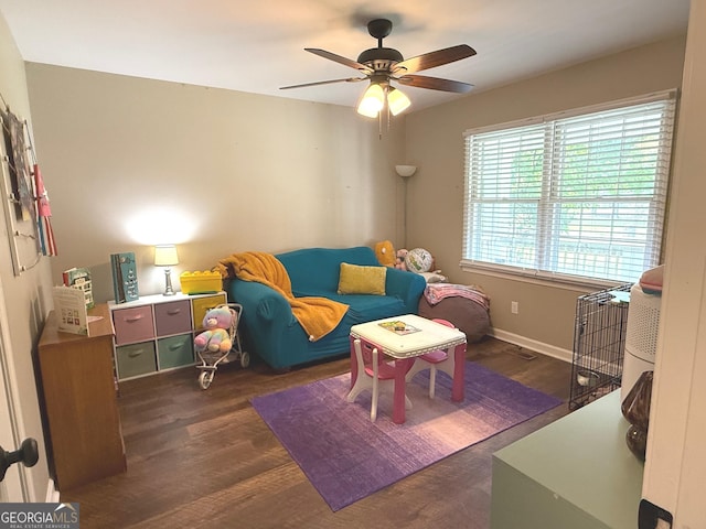 game room with baseboards, a ceiling fan, and wood finished floors
