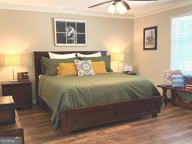 bedroom featuring a ceiling fan, ornamental molding, and wood finished floors
