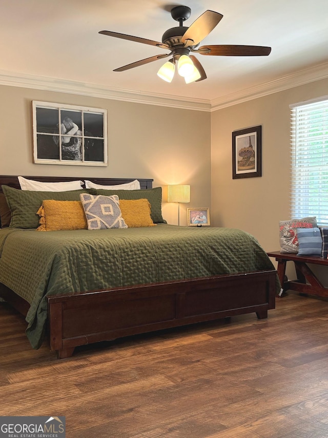 bedroom with crown molding, a ceiling fan, and wood finished floors