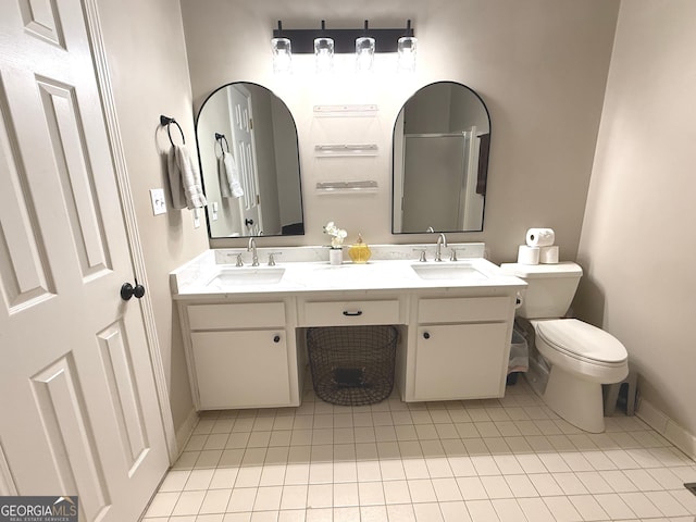 full bath with baseboards, a sink, tile patterned flooring, and toilet