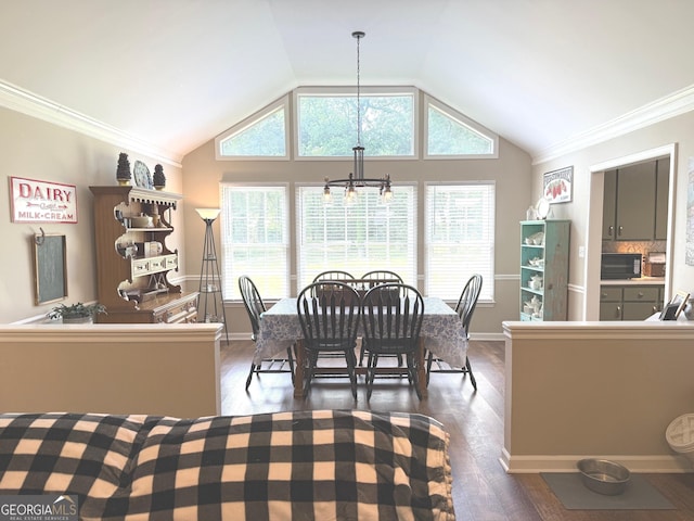 dining area with a healthy amount of sunlight, vaulted ceiling, dark wood-style floors, and a chandelier