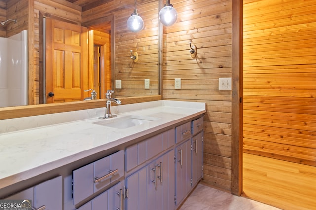 full bathroom with wooden walls and vanity