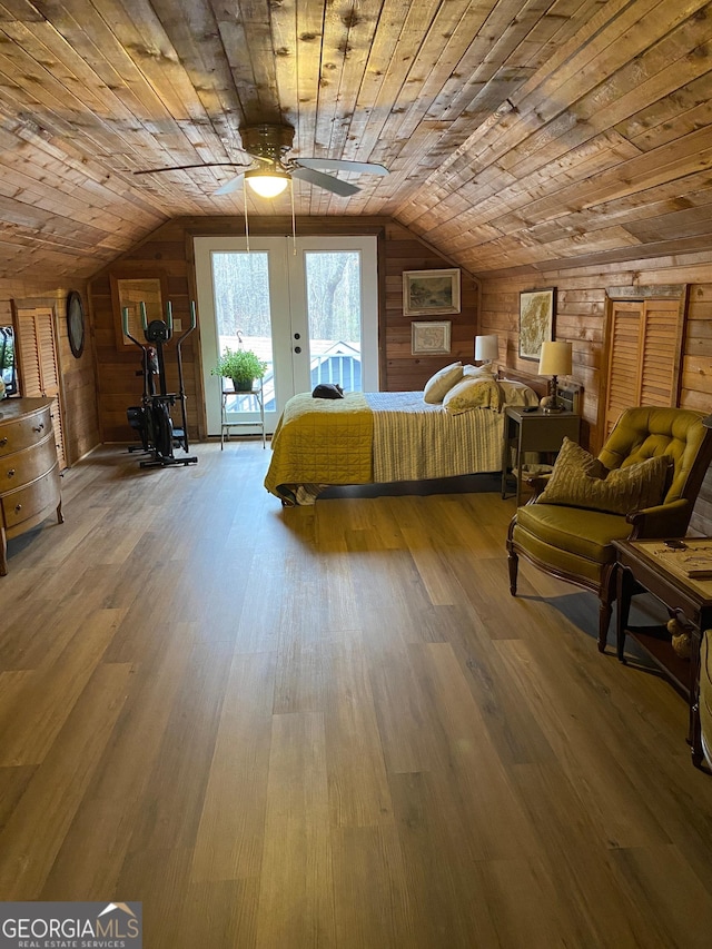 bedroom featuring wood walls, wood ceiling, vaulted ceiling, and access to exterior