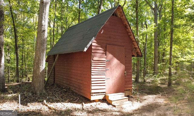 view of shed featuring a wooded view