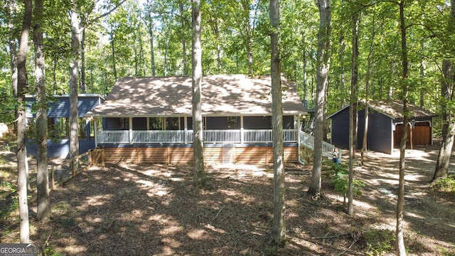 view of front facade with a porch, stairway, and an outdoor structure