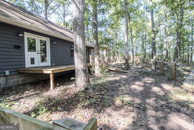 view of yard with a deck, french doors, and fence private yard
