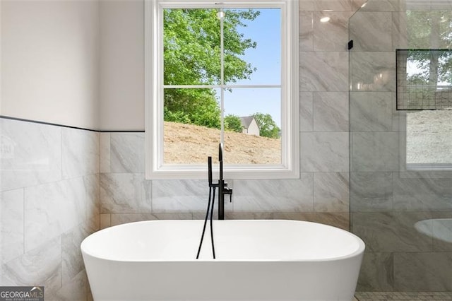 346 Chandler Ct, Alto, GA 30510 - full bathroom featuring a soaking tub, tiled shower, and tile walls
