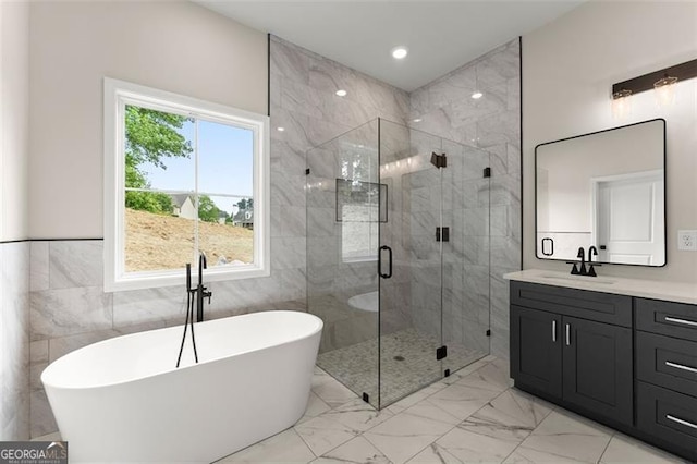 346 Chandler Ct, Alto, GA 30510 - bathroom featuring vanity, marble finish floor, a freestanding tub, tile walls, and a stall shower