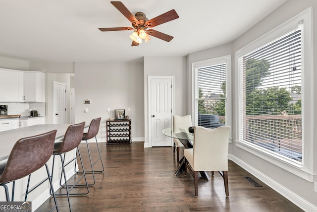 dining room with dark wood-style flooring and baseboards